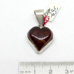 Amber heart pendant on silver. This amber heart is surrounded by silver.