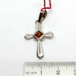 Amber cross pendant on silver. Amber is currently in fashion, women and men are more and more attracted by this noble material.