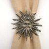 Pewter sun on serviette